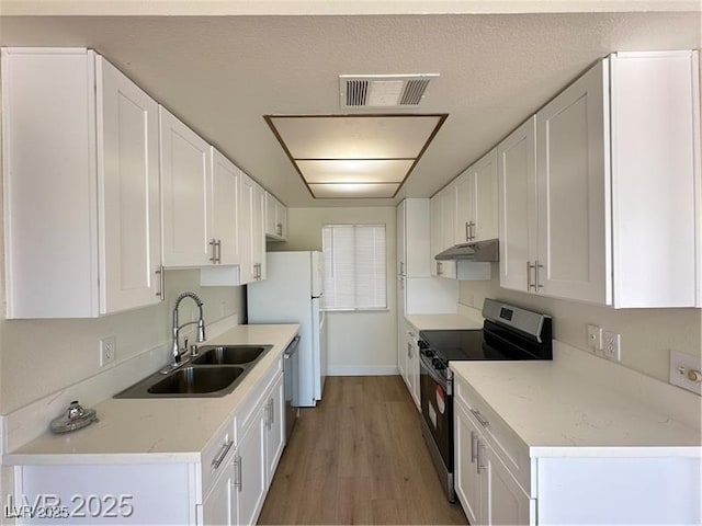 4230 Gannet Cir Unit 216, Las Vegas, NV 89103 - kitchen featuring appliances with stainless steel finishes, white cabinetry, and under cabinet range hood