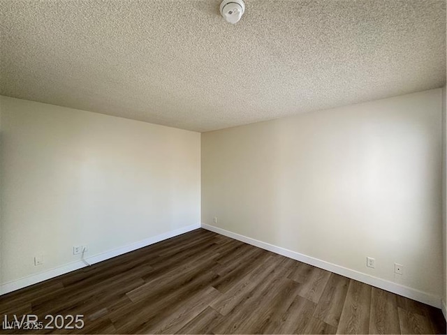 4230 Gannet Cir Unit 216, Las Vegas, NV 89103 - spare room with dark wood-type flooring, a smoke detector, and a textured ceiling