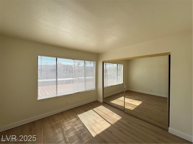 4230 Gannet Cir Unit 216, Las Vegas, NV 89103 - unfurnished room featuring a textured ceiling and wood finished floors