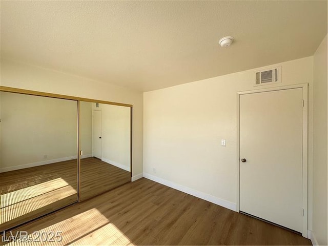 4230 Gannet Cir Unit 216, Las Vegas, NV 89103 - unfurnished bedroom with wood finished floors and a closet