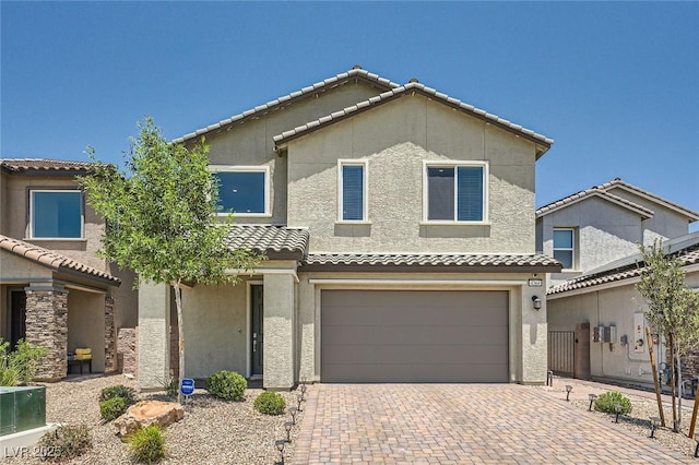 4364 Contour Bend Ave, North Las Vegas, NV 89084 - view of front of house featuring a garage, a tile roof, decorative driveway, and stucco siding