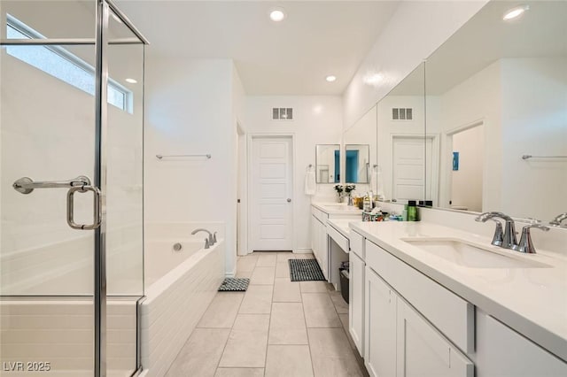 4364 Contour Bend Ave, North Las Vegas, NV 89084 - bathroom with double vanity, a garden tub, a shower stall, tile patterned floors, and recessed lighting