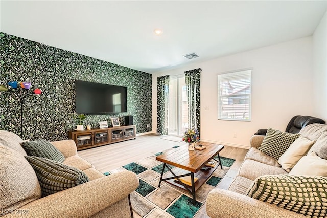 4364 Contour Bend Ave, North Las Vegas, NV 89084 - living area featuring wallpapered walls, wood finished floors, and an accent wall