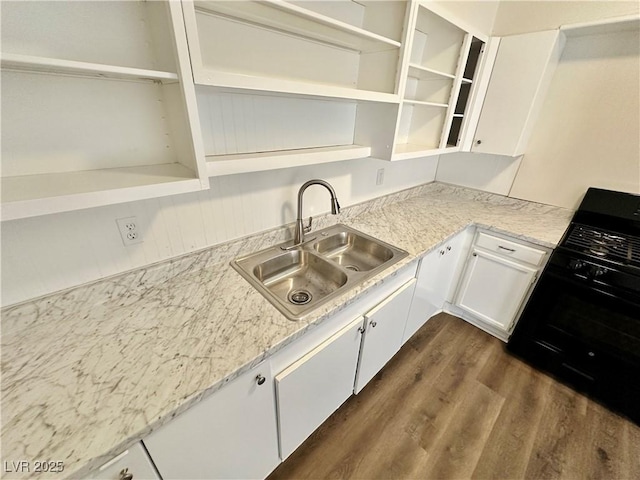 4924 Carmen Blvd, Las Vegas, NV 89108 - kitchen featuring open shelves, gas stove, white cabinets, and dark wood-style floors