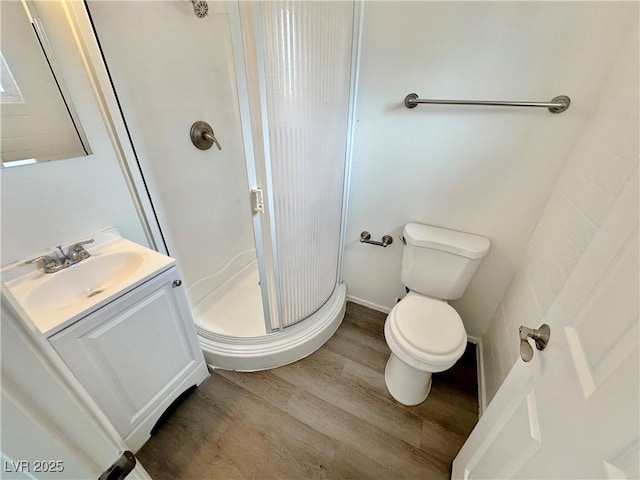 4924 Carmen Blvd, Las Vegas, NV 89108 - full bathroom with wood finished floors, a stall shower, and vanity