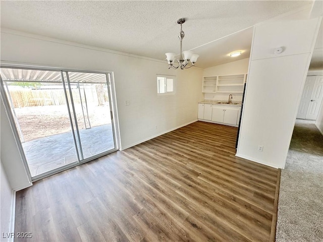4924 Carmen Blvd, Las Vegas, NV 89108 - unfurnished dining area with a chandelier, wood finished floors, and a textured ceiling