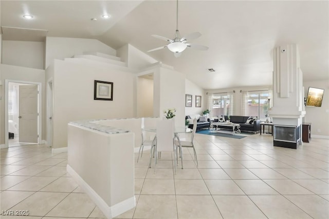 4753 Carefree Dr, Las Vegas, NV 89122 - kitchen featuring lofted ceiling, ceiling fan, light tile patterned floors, open floor plan, and light countertops