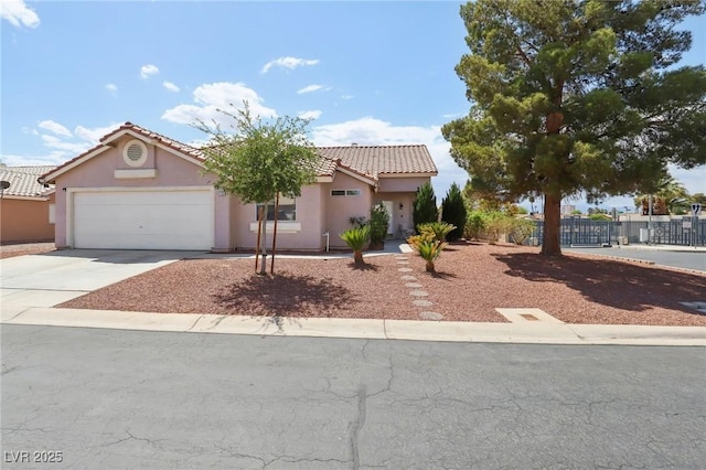 4753 Carefree Dr, Las Vegas, NV 89122 - mediterranean / spanish house featuring concrete driveway, a garage, stucco siding, and a tile roof