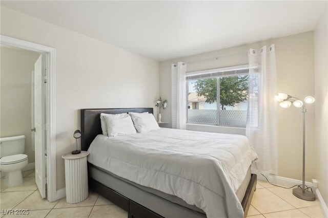 4753 Carefree Dr, Las Vegas, NV 89122 - bedroom featuring light tile patterned flooring and ensuite bath
