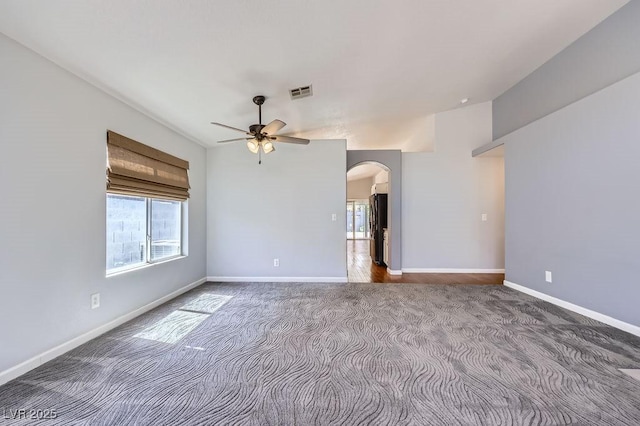 8309 Windrush Ave, Las Vegas, NV 89117 - carpeted empty room with plenty of natural light, arched walkways, and a ceiling fan