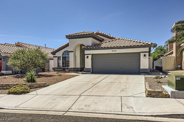 8309 Windrush Ave, Las Vegas, NV 89117 - mediterranean / spanish-style home with a garage, a tile roof, stucco siding, driveway, and a gate