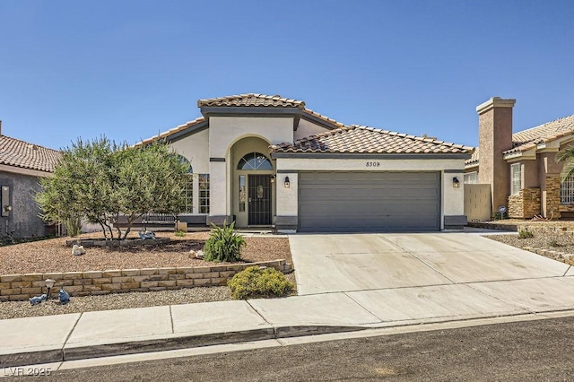 8309 Windrush Ave, Las Vegas, NV 89117 - mediterranean / spanish-style home with an attached garage, stucco siding, a tiled roof, and driveway