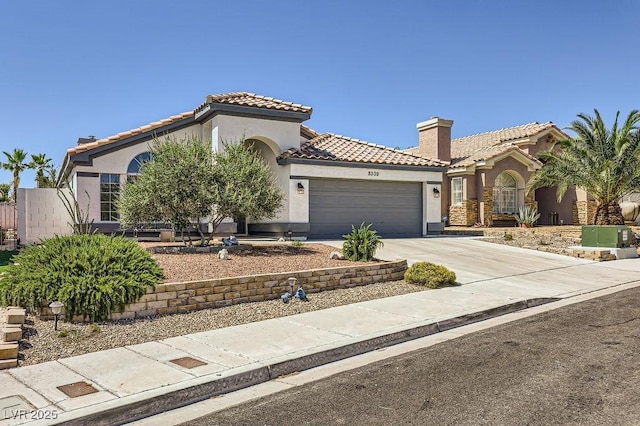 8309 Windrush Ave, Las Vegas, NV 89117 - mediterranean / spanish home with stucco siding, a garage, a tile roof, and concrete driveway
