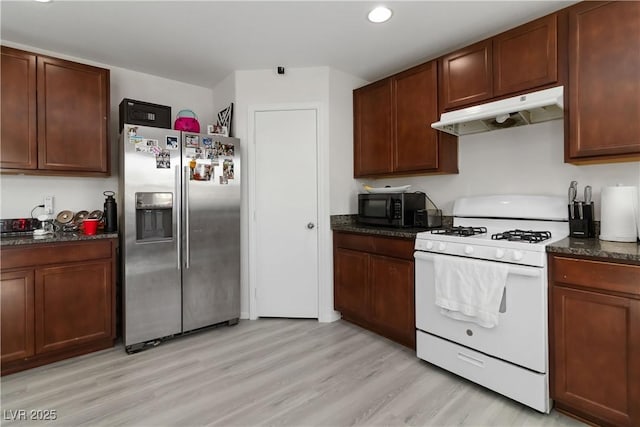 4976 Quiet Morning St, Las Vegas, NV 89122 - kitchen with stainless steel fridge, white range with gas cooktop, under cabinet range hood, black microwave, and light wood-style floors