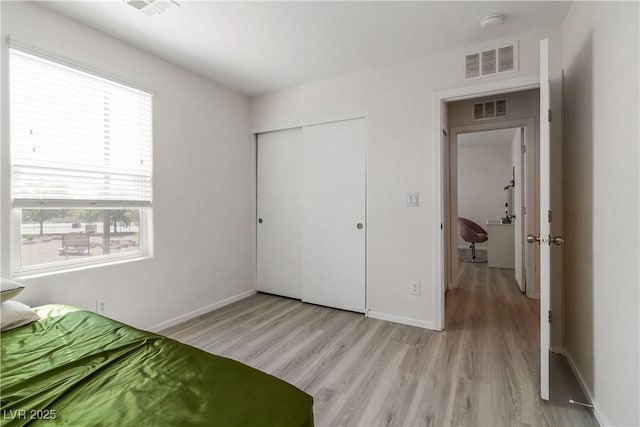 4976 Quiet Morning St, Las Vegas, NV 89122 - bedroom featuring light wood-style floors, multiple windows, and a closet
