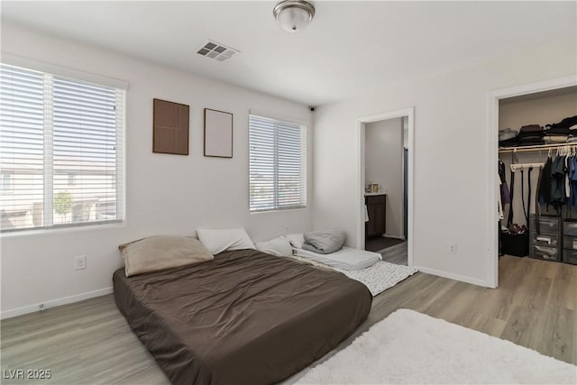 4976 Quiet Morning St, Las Vegas, NV 89122 - bedroom with multiple windows, wood finished floors, a spacious closet, and a closet