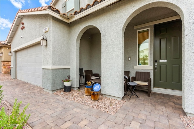 7502 Lush Oasis Ave, Las Vegas, NV 89113 - entrance to property featuring stucco siding, a tile roof, an attached garage, and driveway