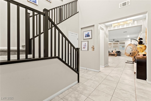 7502 Lush Oasis Ave, Las Vegas, NV 89113 - staircase with tile patterned floors and a chandelier