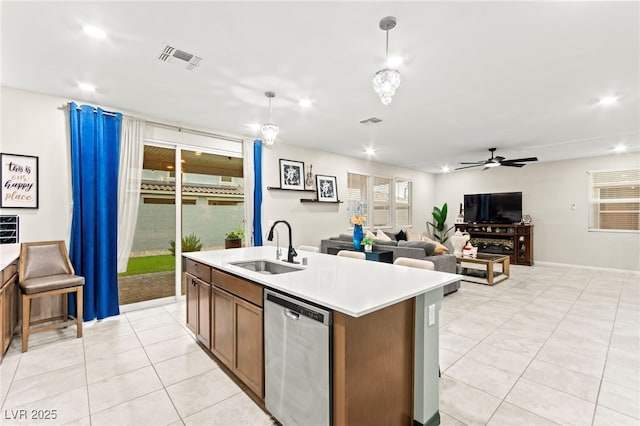 7502 Lush Oasis Ave, Las Vegas, NV 89113 - kitchen with dishwasher, light countertops, a ceiling fan, a kitchen island with sink, and light tile patterned floors