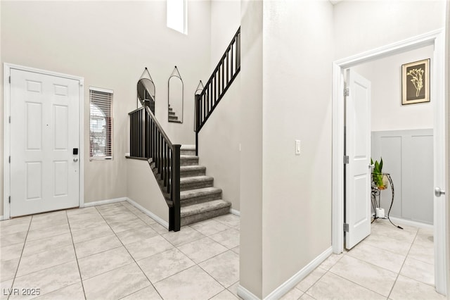 7502 Lush Oasis Ave, Las Vegas, NV 89113 - entrance foyer with stairs, light tile patterned floors, and a high ceiling