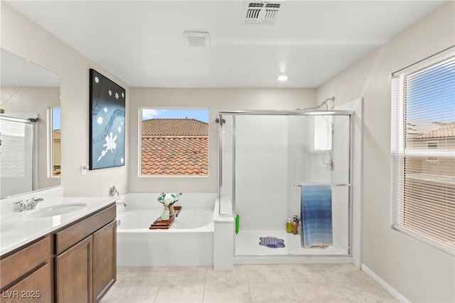 7502 Lush Oasis Ave, Las Vegas, NV 89113 - bathroom featuring a garden tub, vanity, a shower stall, and plenty of natural light