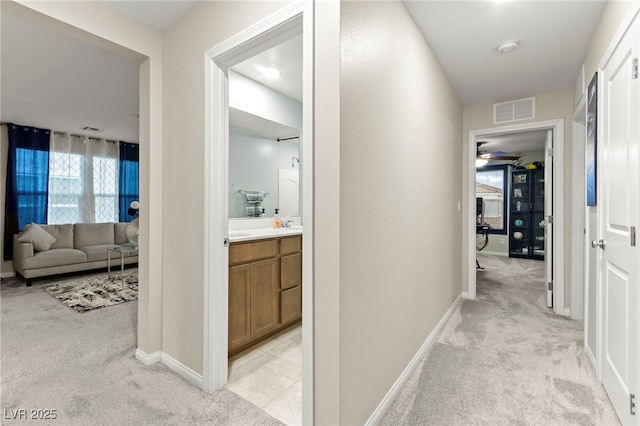 7502 Lush Oasis Ave, Las Vegas, NV 89113 - hall featuring light carpet and baseboards