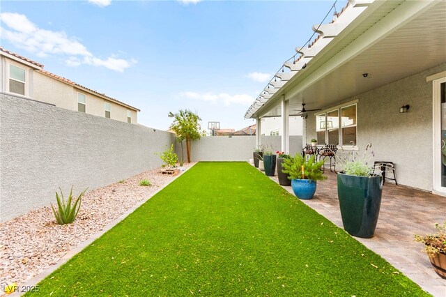 7502 Lush Oasis Ave, Las Vegas, NV 89113 - fenced backyard with a patio area and ceiling fan