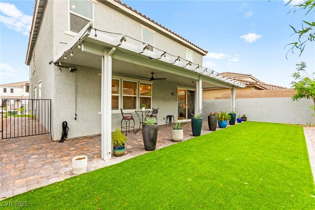 7502 Lush Oasis Ave, Las Vegas, NV 89113 - back of property with stucco siding, a fenced backyard, a patio, ceiling fan, and a tiled roof
