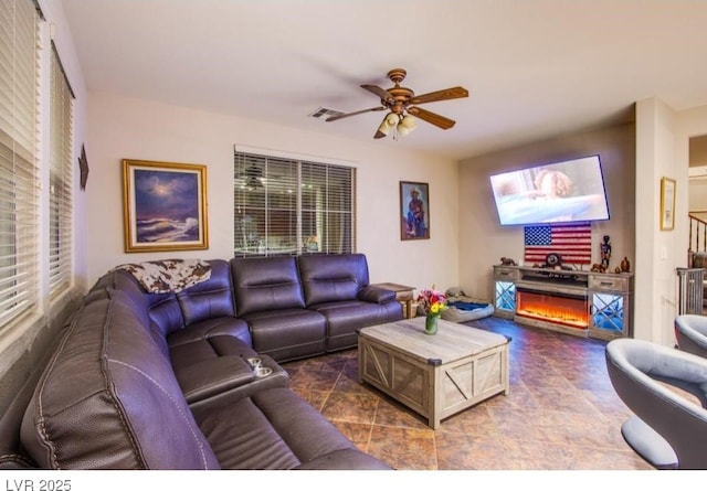 1557 Blue Sierra Ct, Henderson, NV 89074 - living area with ceiling fan and a lit fireplace