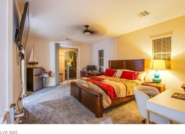 1557 Blue Sierra Ct, Henderson, NV 89074 - bedroom featuring freestanding refrigerator, access to outside, carpet floors, and a ceiling fan