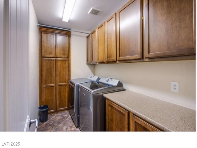 1557 Blue Sierra Ct, Henderson, NV 89074 - laundry room featuring cabinet space, independent washer and dryer, and dark tile patterned floors