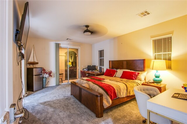 1557 Blue Sierra Ct, Henderson, NV 89074 - carpeted bedroom featuring freestanding refrigerator, access to outside, and a ceiling fan