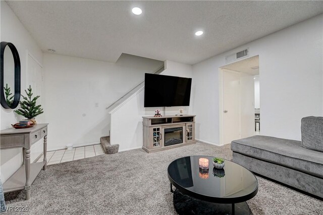 7066 Burcot Ave Unit 59, Las Vegas, NV 89156 - carpeted living area with stairs, a textured ceiling, recessed lighting, and tile patterned floors