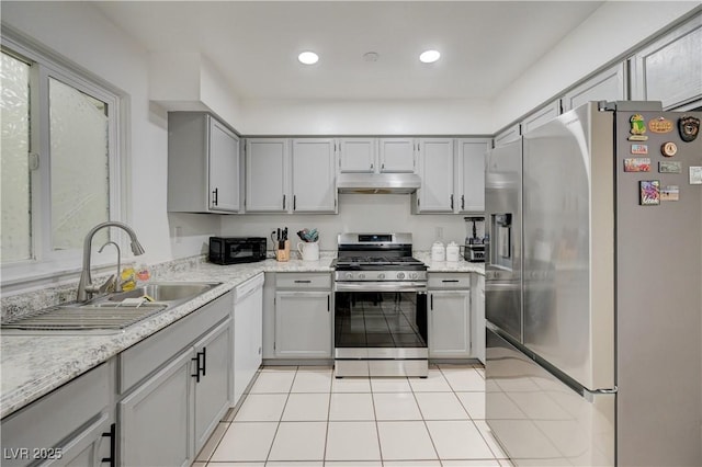 7066 Burcot Ave Unit 59, Las Vegas, NV 89156 - kitchen featuring appliances with stainless steel finishes, under cabinet range hood, light tile patterned flooring, gray cabinets, and recessed lighting