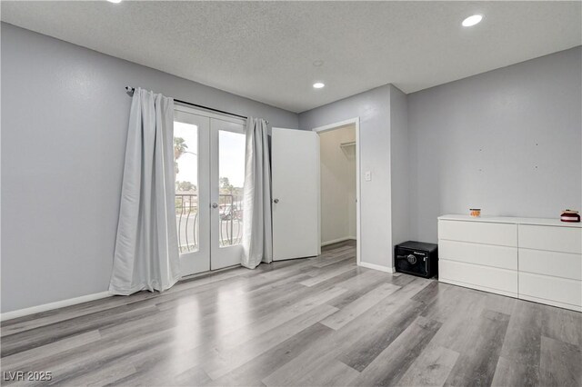 7066 Burcot Ave Unit 59, Las Vegas, NV 89156 - spare room featuring french doors, wood finished floors, recessed lighting, and a textured ceiling