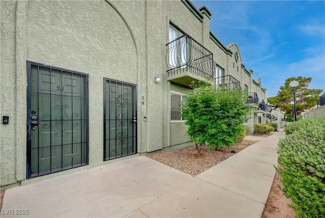7066 Burcot Ave Unit 59, Las Vegas, NV 89156 - entrance to property featuring stucco siding, a balcony, and a patio area