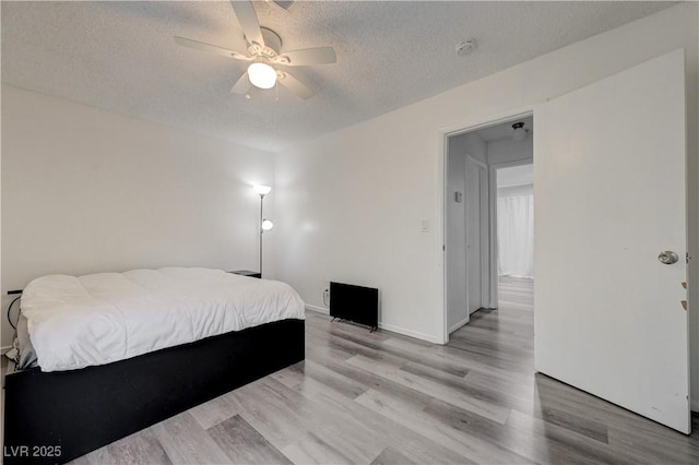 7066 Burcot Ave Unit 59, Las Vegas, NV 89156 - bedroom with a textured ceiling, light wood-style flooring, and ceiling fan
