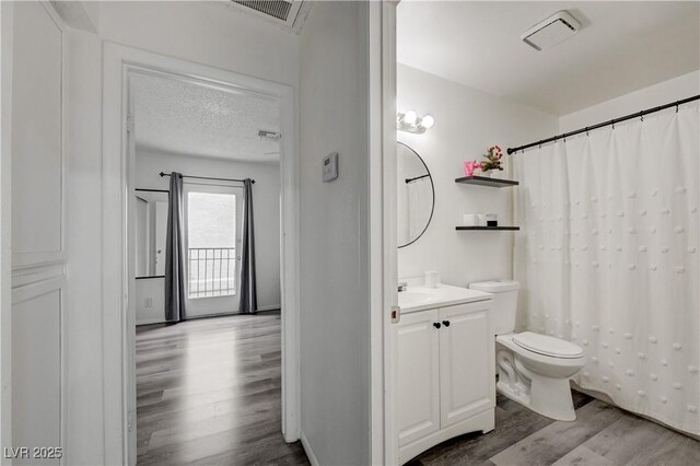 7066 Burcot Ave Unit 59, Las Vegas, NV 89156 - full bathroom featuring wood finished floors, vanity, a textured ceiling, and a shower with curtain