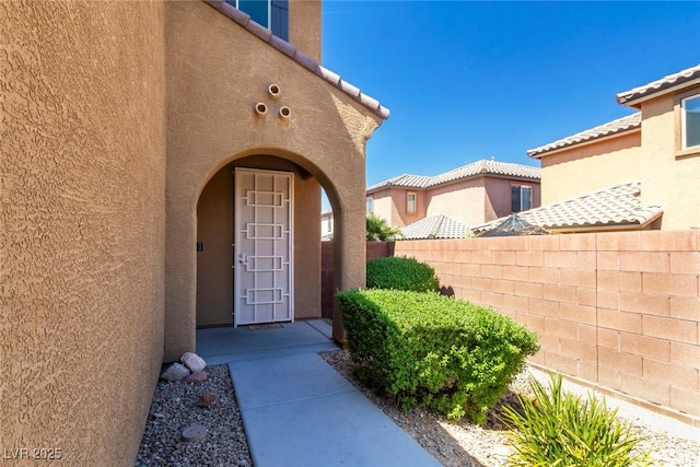 7652 Silver Baron Rd, Las Vegas, NV 89179 - entrance to property featuring stucco siding and a tiled roof