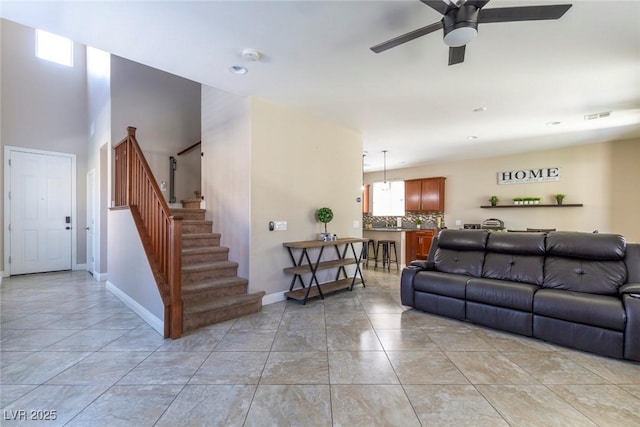 7652 Silver Baron Rd, Las Vegas, NV 89179 - living room with ceiling fan, stairs, and light tile patterned floors
