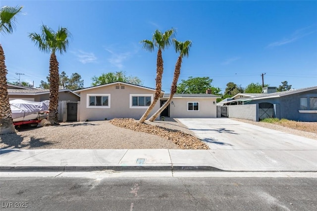 212 View Dr, Las Vegas, NV 89107 - ranch-style house with concrete driveway, stucco siding, and a gate