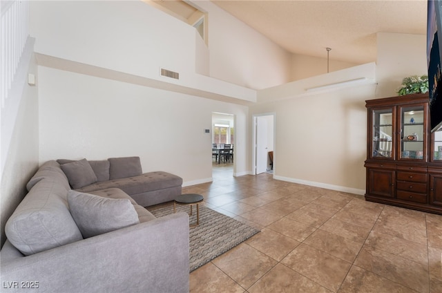 309 Clifton Heights Dr, Las Vegas, NV 89145 - living area featuring light tile patterned floors and lofted ceiling
