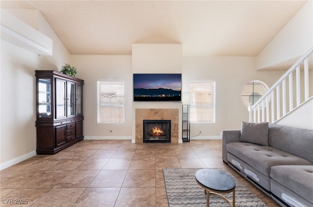 309 Clifton Heights Dr, Las Vegas, NV 89145 - living room featuring plenty of natural light, a fireplace, light tile patterned floors, and stairs
