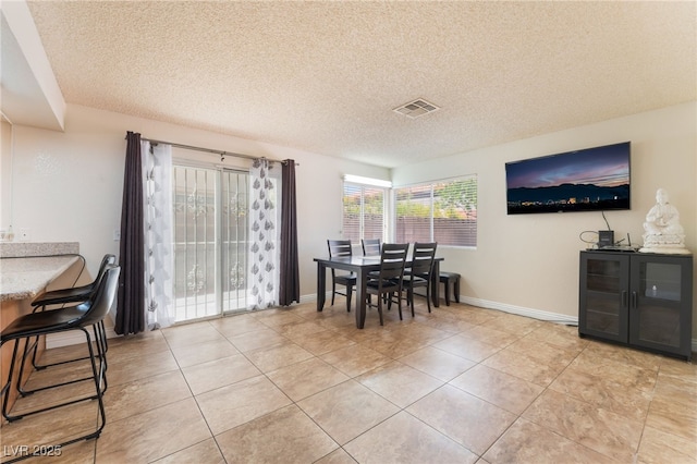 309 Clifton Heights Dr, Las Vegas, NV 89145 - dining area with light tile patterned floors and a textured ceiling