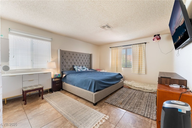 309 Clifton Heights Dr, Las Vegas, NV 89145 - bedroom with radiator heating unit, tile patterned floors, and a textured ceiling