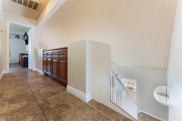 309 Clifton Heights Dr, Las Vegas, NV 89145 - corridor featuring a textured ceiling and dark tile patterned flooring