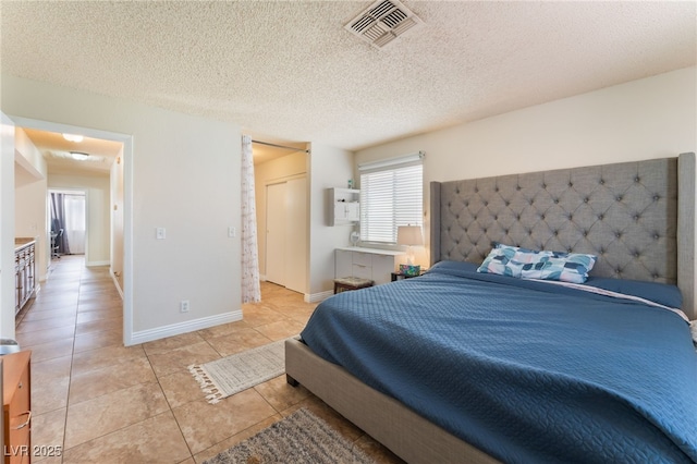 309 Clifton Heights Dr, Las Vegas, NV 89145 - bedroom featuring light tile patterned flooring and a textured ceiling