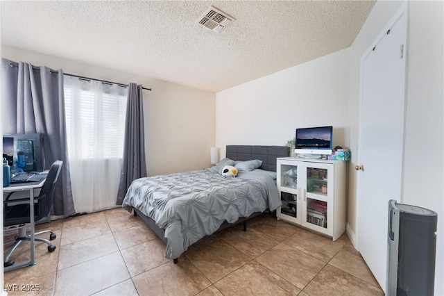 309 Clifton Heights Dr, Las Vegas, NV 89145 - bedroom featuring a textured ceiling and light tile patterned floors