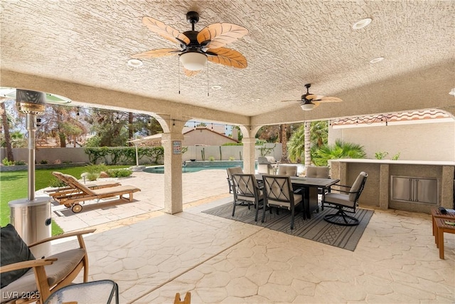 1990 Freeman Ct, Henderson, NV 89014 - fenced backyard with a ceiling fan, outdoor dining area, and a patio
