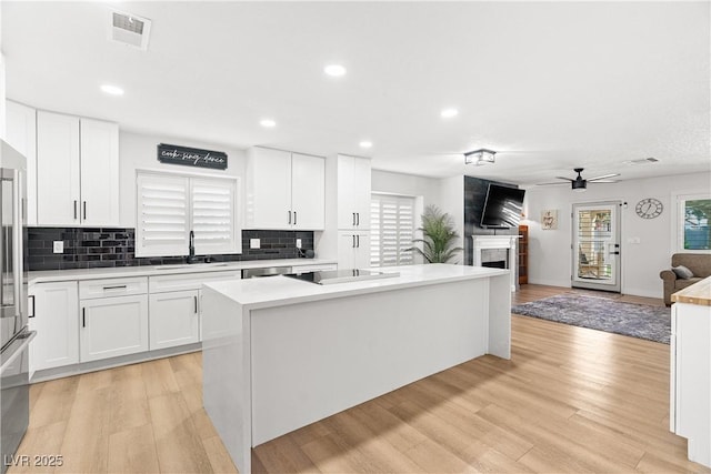 1990 Freeman Ct, Henderson, NV 89014 - kitchen featuring a fireplace, decorative backsplash, healthy amount of natural light, and recessed lighting